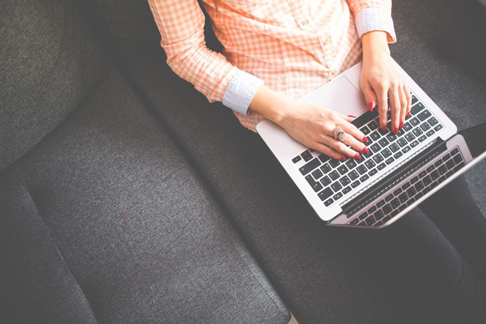 Woman using laptop on couch
