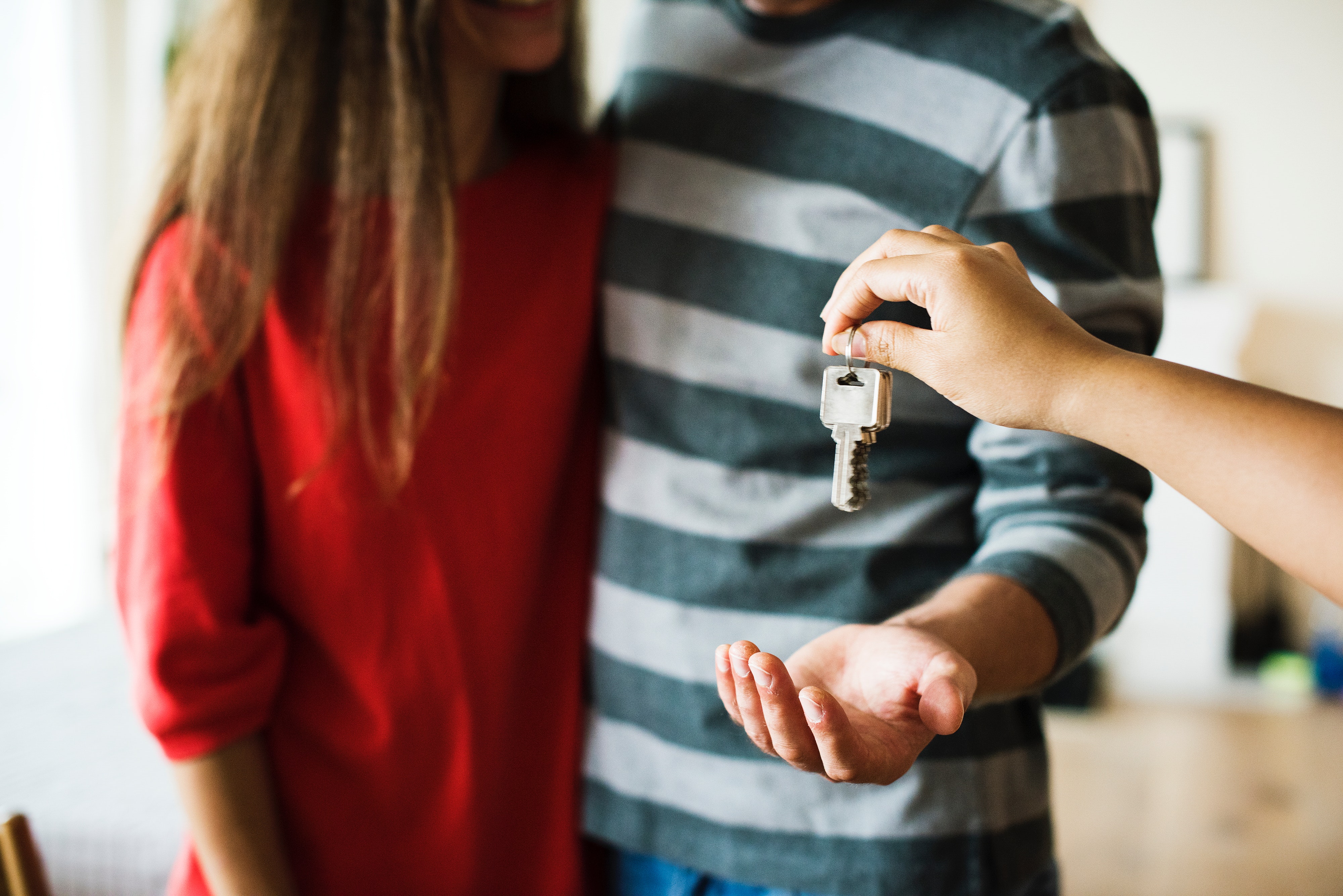person handing keys